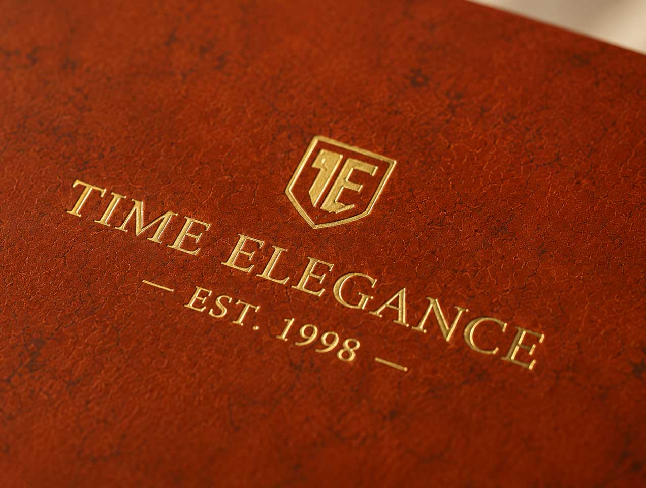 Metallic gold foil creates a clear contrast against the brown surface, helping logos and lettering stand out.