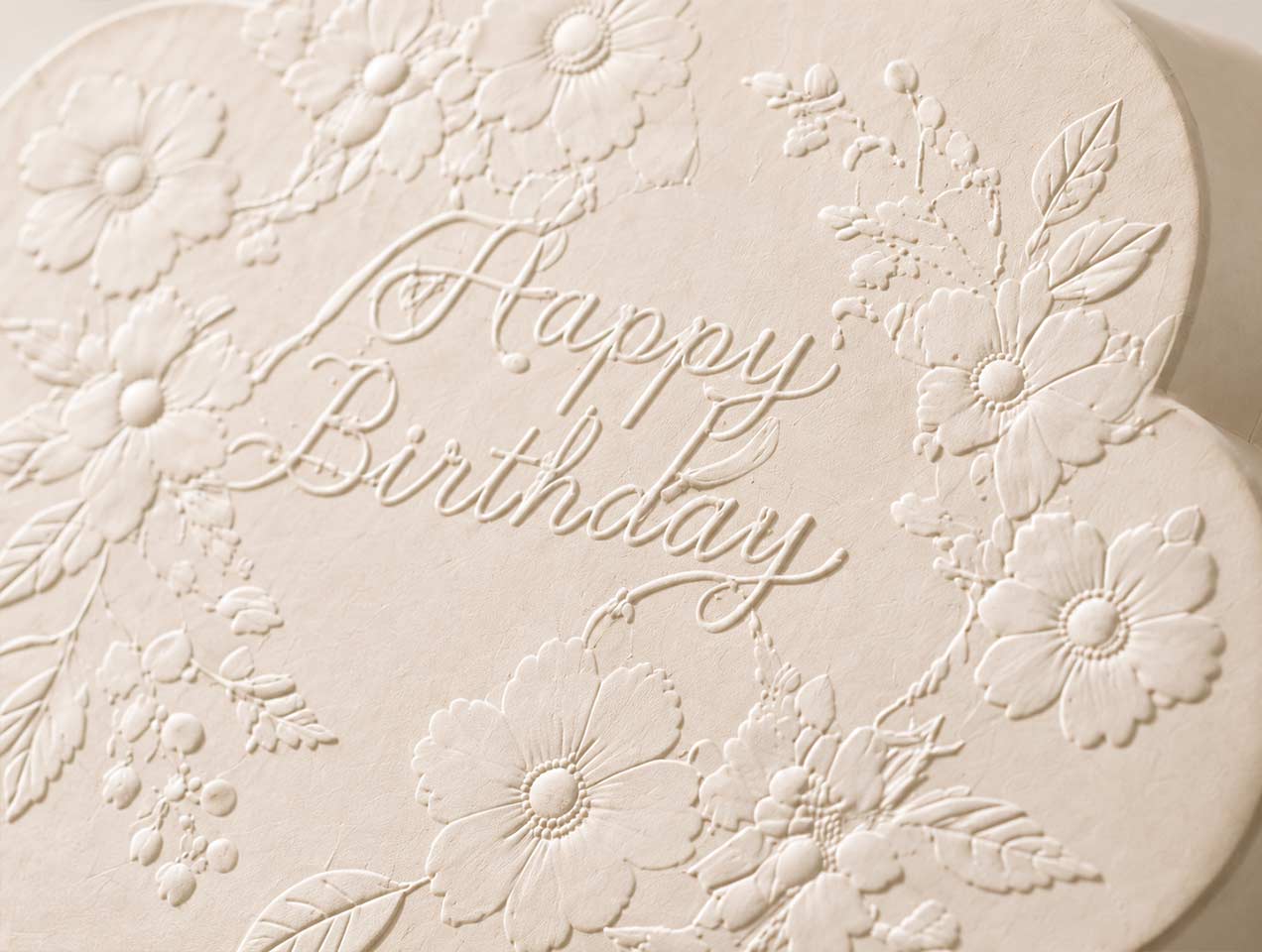 Raised flowers and lettering add visible texture without extra colors.